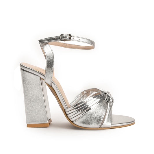 A silver-colored sandal with a block heel and an open-toe strap.