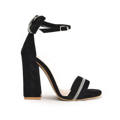 A black pencil heel sandal with a decorative stripe on the sole.