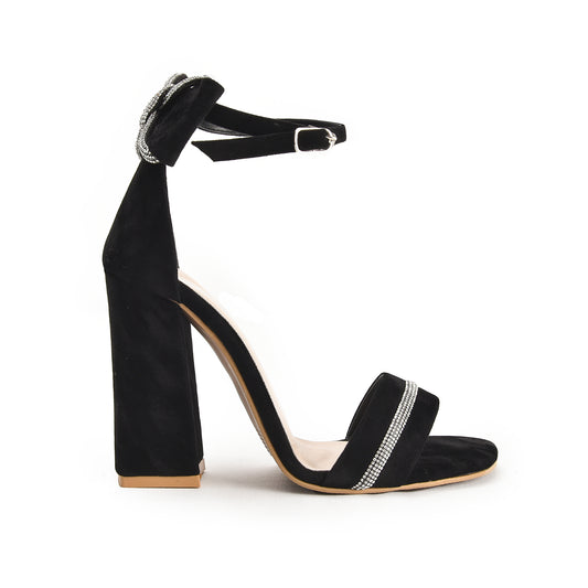 A black pencil heel sandal with a decorative stripe on the sole.