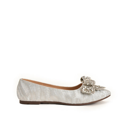 A silver-colored, suede pump with a decorative heel and a bow on the vamp.