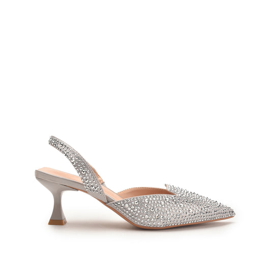 A pair of silver-heeled sandals with a pointed toe and decorative straps.
