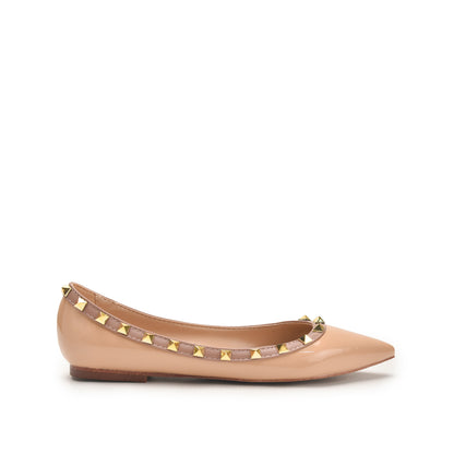 A pink shoe with gold-colored accents and a textured sole.