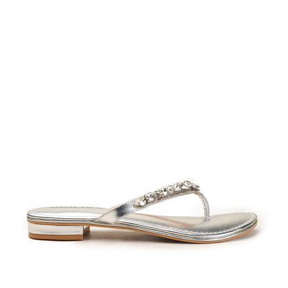 Silver sandal with a strap and embellishments on a white background